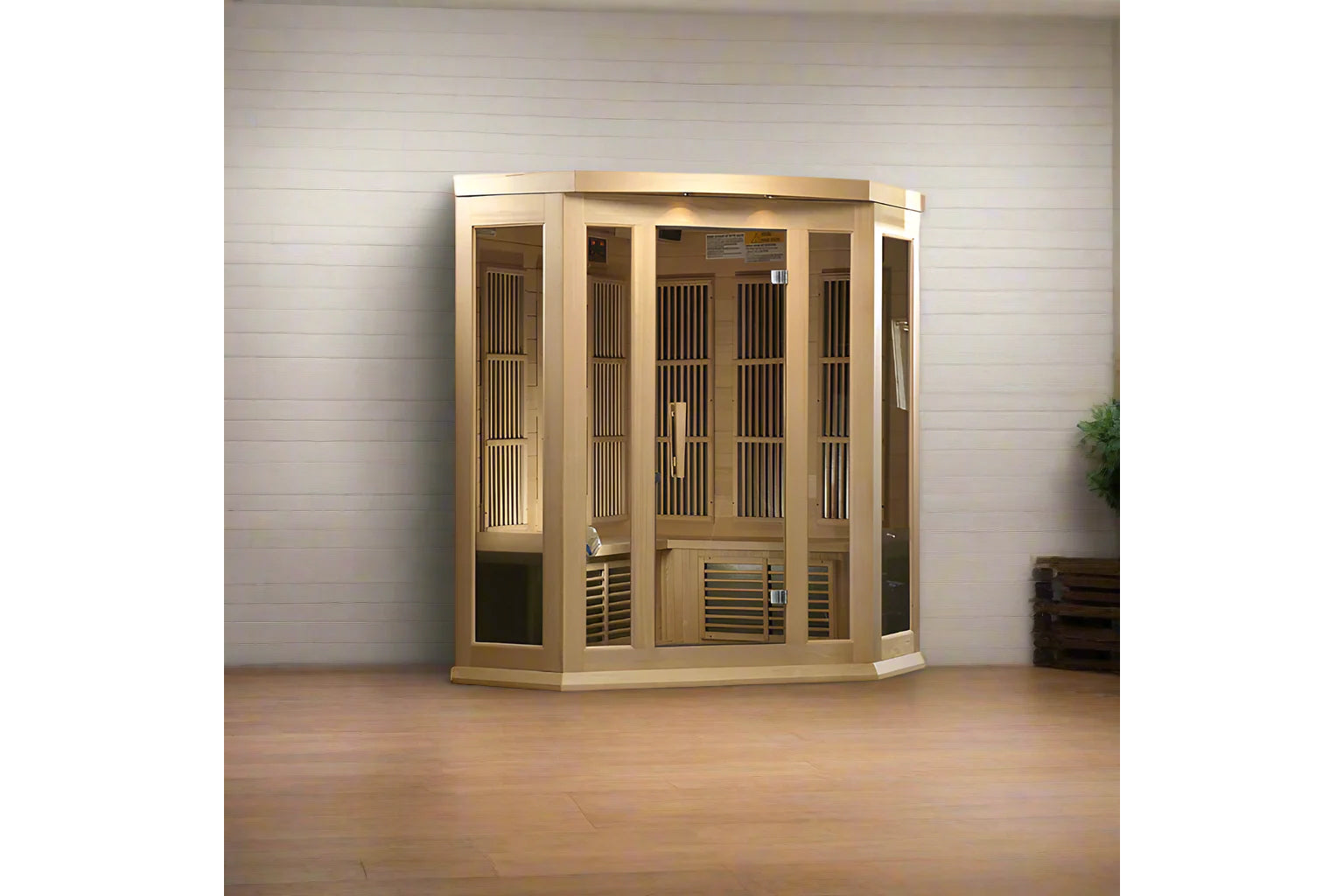 Light wood corner sauna with glass front doors, vertical slat venting panels, and interior bench seating against white wall o