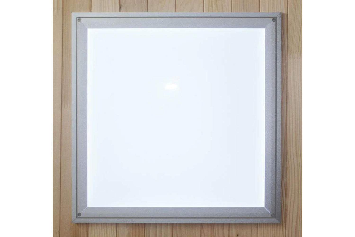 Silver-framed square mirror with white center and corner mounting hardware on wooden background