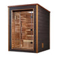 Modern sauna cabin with light cedar wood interior and dark exterior frame, glass door with black handles, bench seating, and 