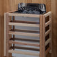 Natural wood sauna stove with black metal top and storage shelves, displayed on wooden floor background
