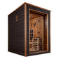 Modern sauna cabin with black exterior walls, wood frame trim, and glass front door revealing natural wood interior with benc