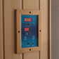 Natural wood control panel with blue face displaying red LED temperature and time readouts, mounted on wooden wall