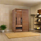 Cedar wood infrared sauna with glass door and wooden benches, shown in spa bathroom setting with beige tile walls and shelvin