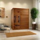 Cedar wood infrared sauna with glass door panel and bench seating in modern bedroom setting