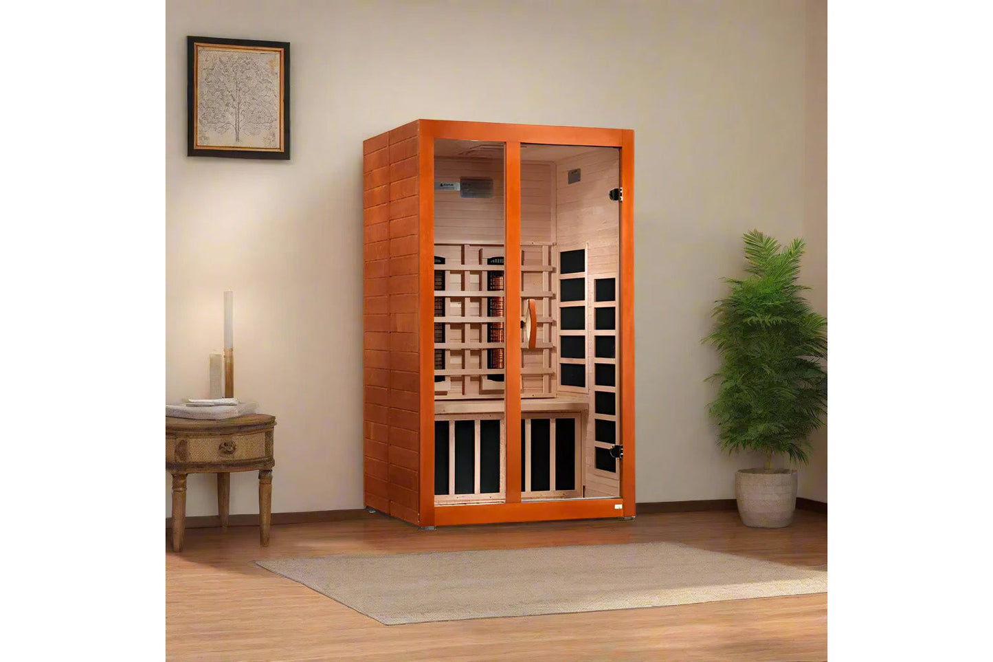 Orange framed two-person infrared sauna with glass doors and light wood interior, shown in room setting with decorative plant