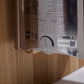 The Wall brand sauna specifications label showing technical data, floor area coverage, IPX4 rating, and QR code on white back