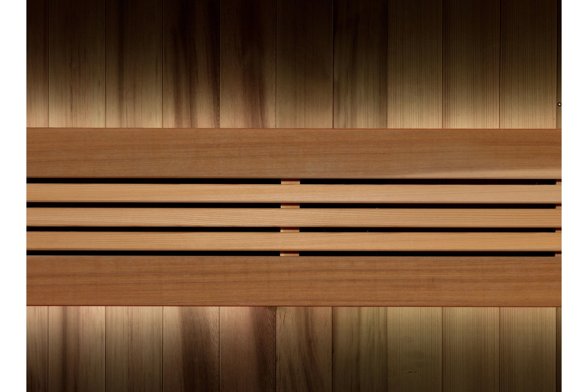 Wooden sauna interior with vertical paneling in warm brown tones and horizontal slat bench seating detail