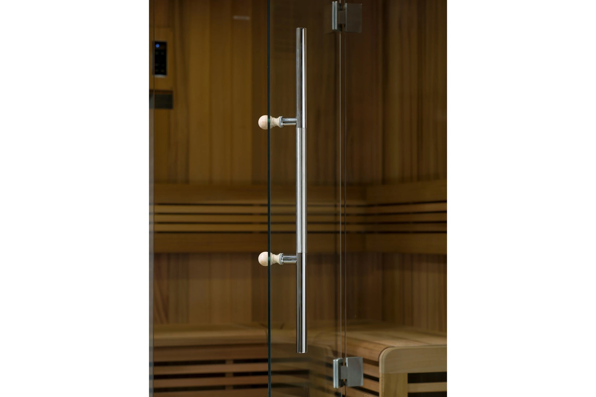 Glass sauna door with chrome handle and pearl knob hardware on wooden sauna cabinet with horizontal slats