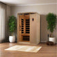 Golden Designs Venice Elite 2-person infrared sauna with natural wood exterior and glass door panels, flanked by potted plant