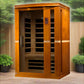 Golden Designs Vittoria 2-person far infrared sauna with golden wood exterior and glass doors in outdoor garden setting