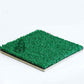 Artificial turf sample with bright green pile on tan backing, shown at angle on white background