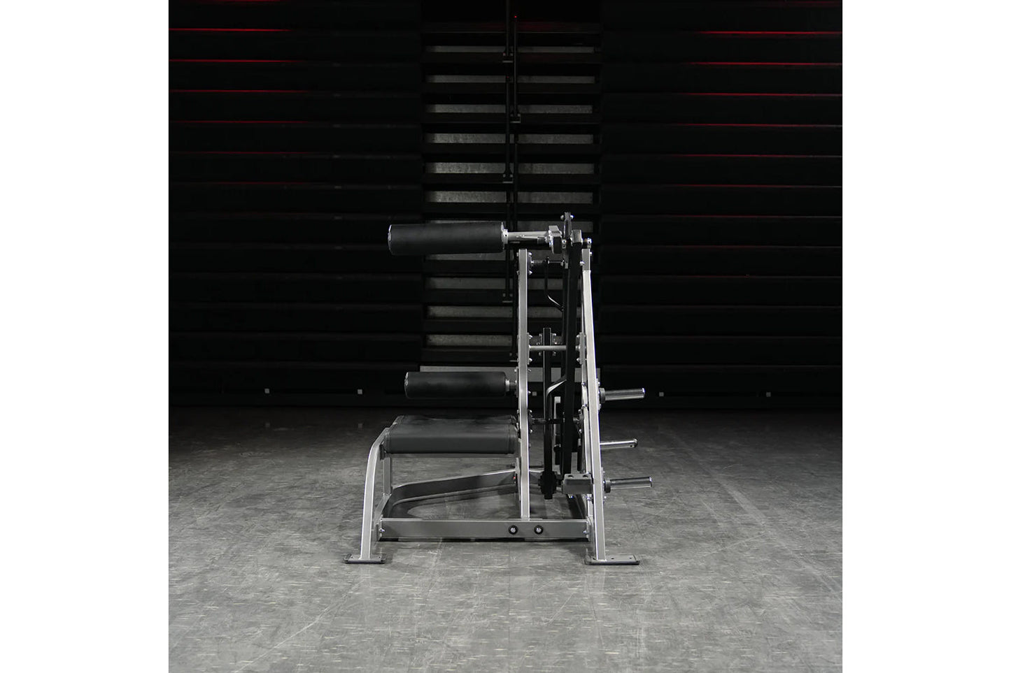 Hammer Strength Assisted Nordic Ham machine with silver frame and black rollers on gray gym floor