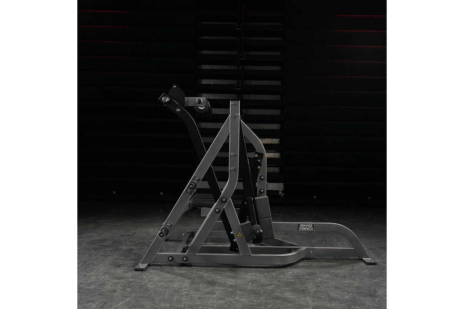 Black Hammer Strength assisted Nordic ham machine with metal frame and foot platform on gray concrete floor