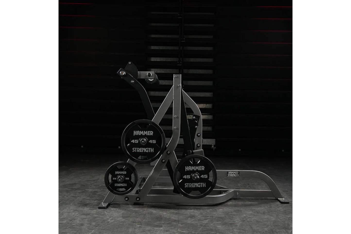 Hammer Strength Assisted Nordic Ham machine with black weight plates and steel frame on gray floor