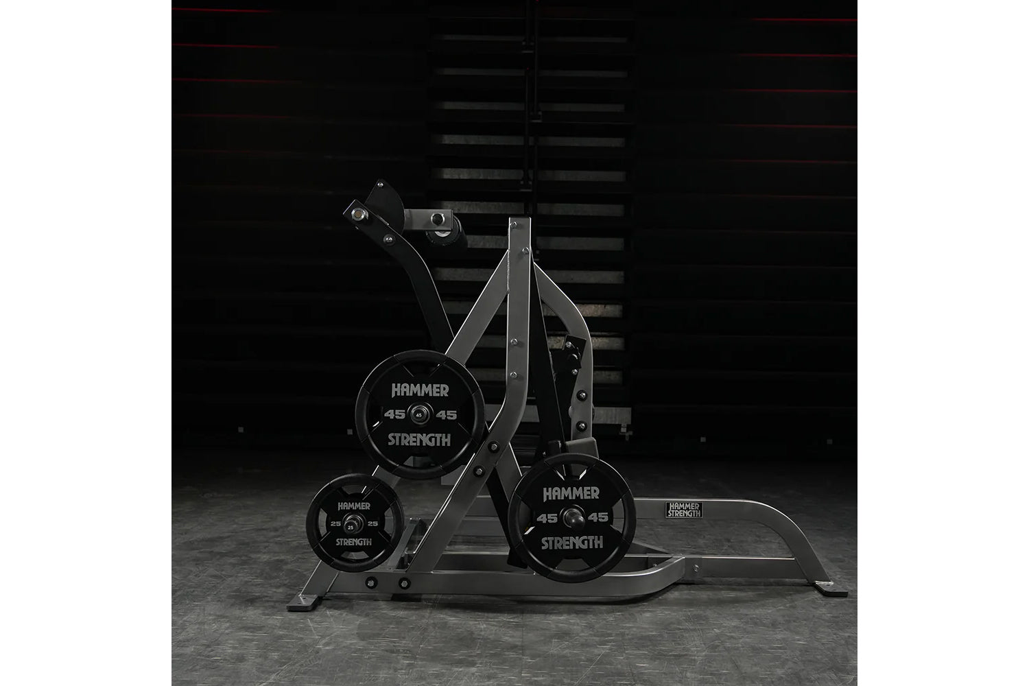 Hammer Strength Assisted Nordic Ham machine with black weight plates and steel frame on gray floor