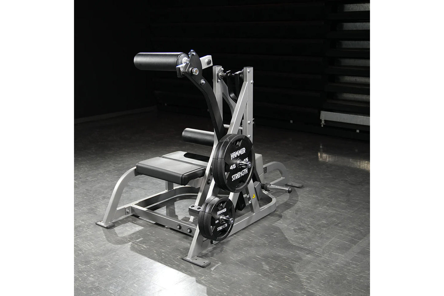 Hammer Strength assisted Nordic ham machine with silver frame, black padded seat, and dual weight plates labeled 45 lbs