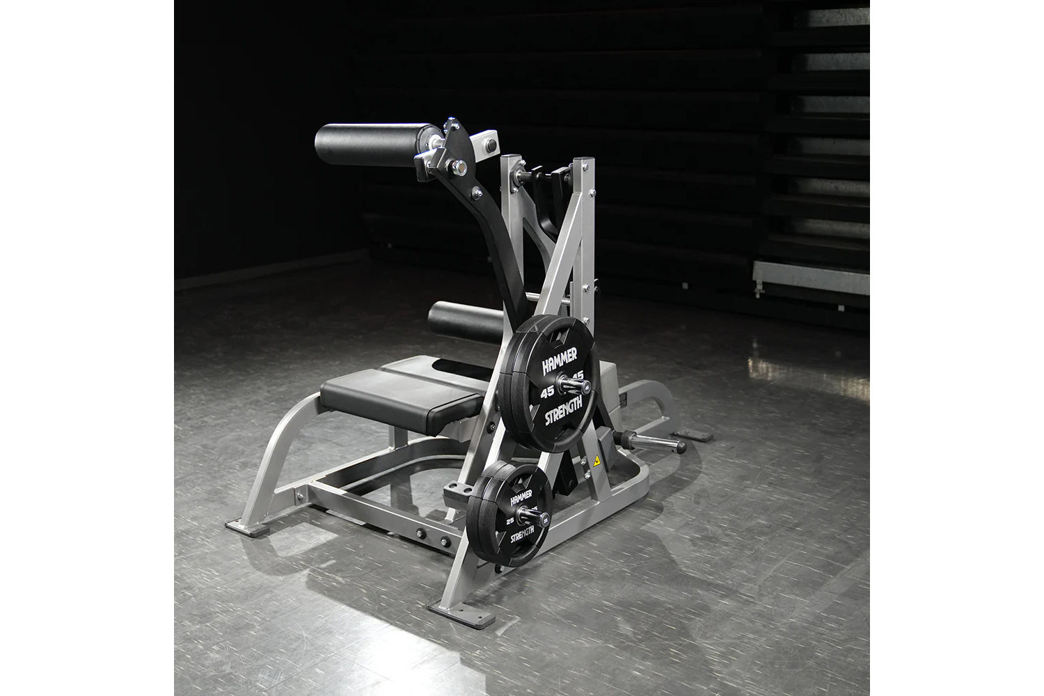 Hammer Strength assisted Nordic ham machine with silver frame, black padded seat, and dual weight plates labeled 45 lbs