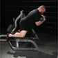 Man using Hammer Strength leg curl machine with adjustable weights, demonstrating exercise form in gym setting