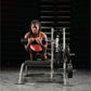 Woman wearing coral sports bra and black shorts performing dumbbell exercise on weight bench in gym setting