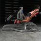 Woman using black and gray Hammer Strength leg press machine with red sneakers in gym setting