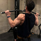 Man performing lat pulldown exercise on Hammer Strength dual pulldown/row machine in gym, wearing black sleeveless shirt