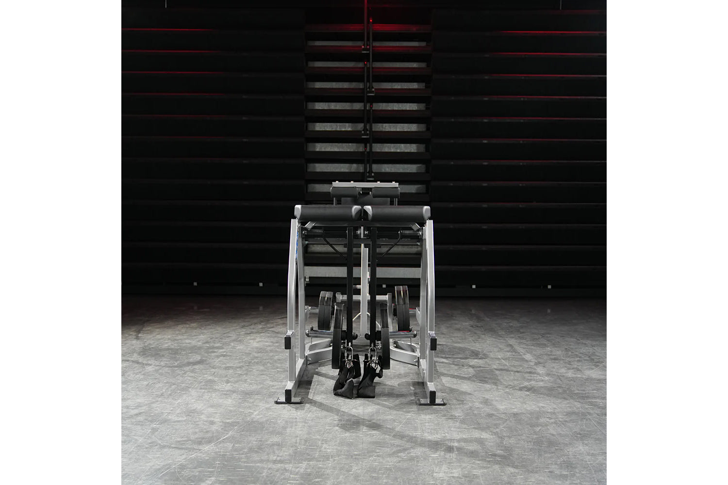 Hammer Strength Glute-Ham Reverse Hyper Combo Bench Machine with silver frame and black padding in gym setting