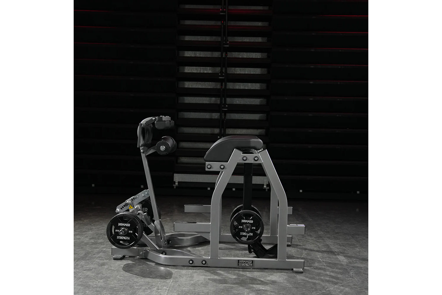 Hammer Strength gray and black glute-ham reverse hyper combo machine with weight plates, in industrial gym setting
