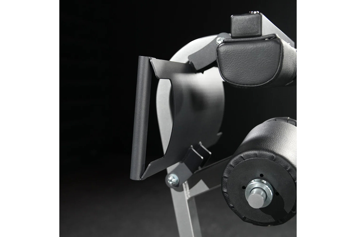 Black and gray exercise machine with padded leather seat, leg extension attachment, and control dial on black background