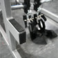 Black and gray metal exercise machine with textured foot platform and lever handles, close-up detail view