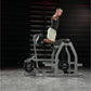 Man performing reverse hyper exercise on gray Hammer Strength machine with black weight plates in gym setting