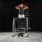 Man performing exercise on Hammer Strength Glute-Ham Reverse Hyper Combo machine, wearing charcoal tank top and cream shorts 