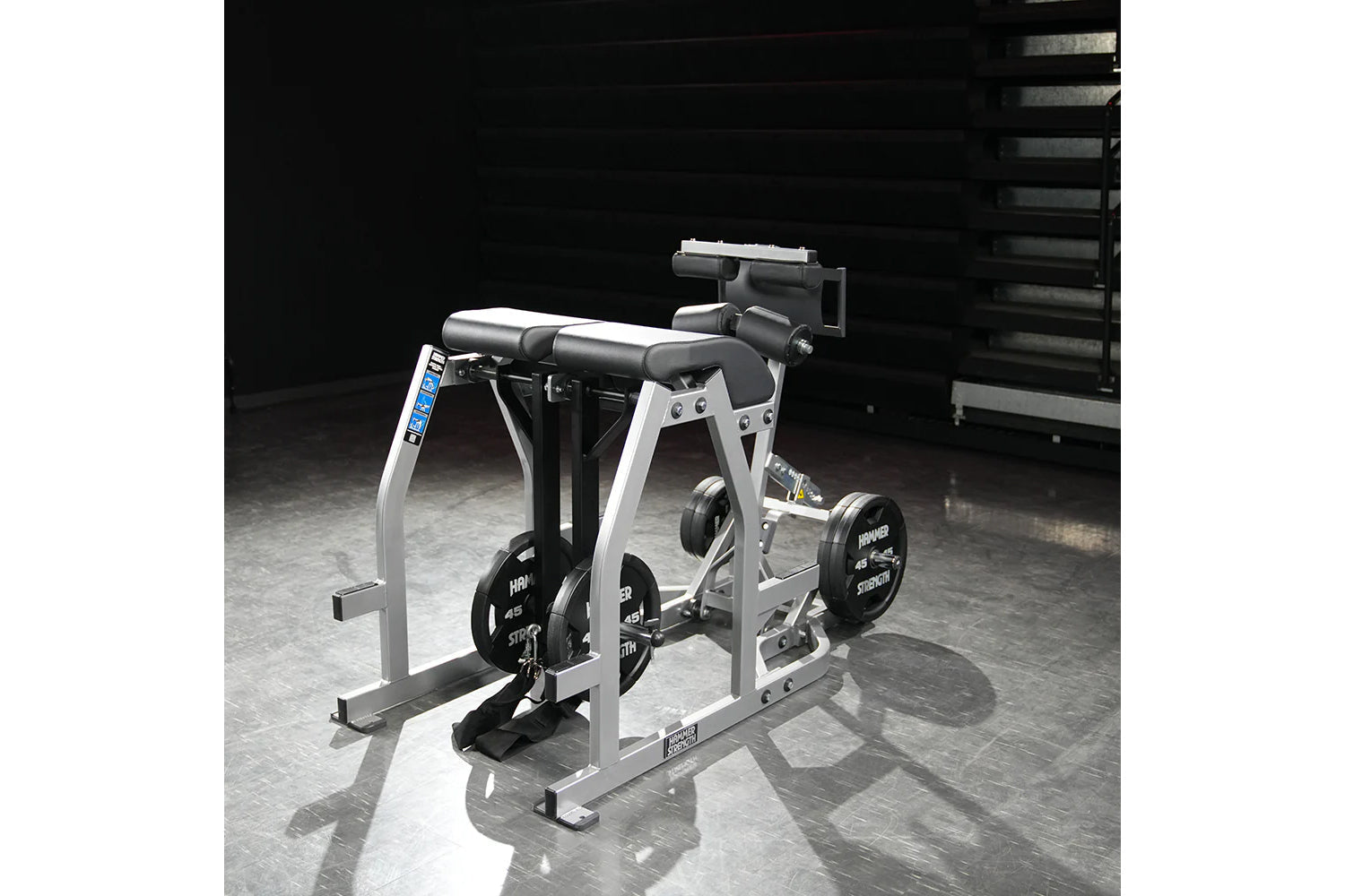 Hammer Strength white and black glute-ham reverse hyper combo bench machine with weight plates on gym floor