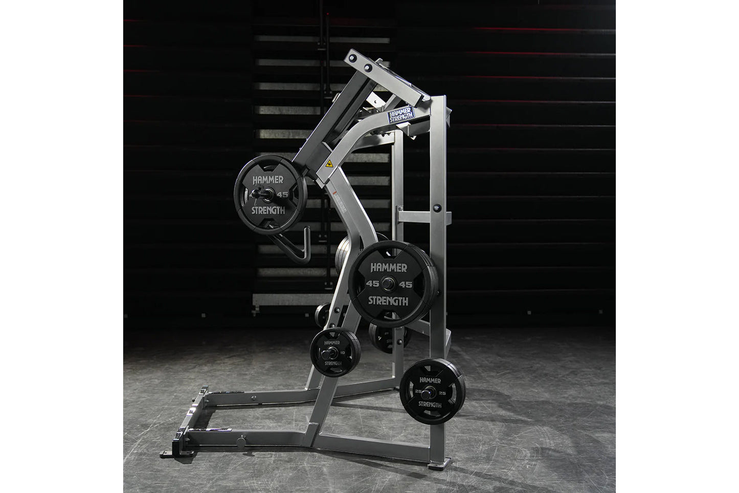 Hammer Strength Ground Base Jammer with silver frame and black weight plates loaded on machine in gym setting