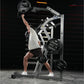 Man using Hammer Strength jammer machine with 45-lb plate, white and black metal frame, gym setting with red rope background