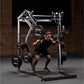 Male athlete using Hammer Strength black and silver ground base jammer machine with loaded weight plates in gym setting