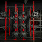 Hammer Strength red and black half combo power rack with loaded Olympic weight plates and barbell sleeves in gym setting