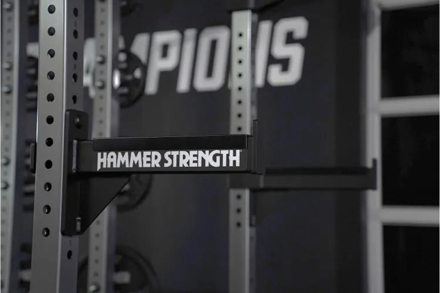 Hammer Strength HD Athletic NX half rack with white text on black horizontal band, silver upright posts with black holes, sho