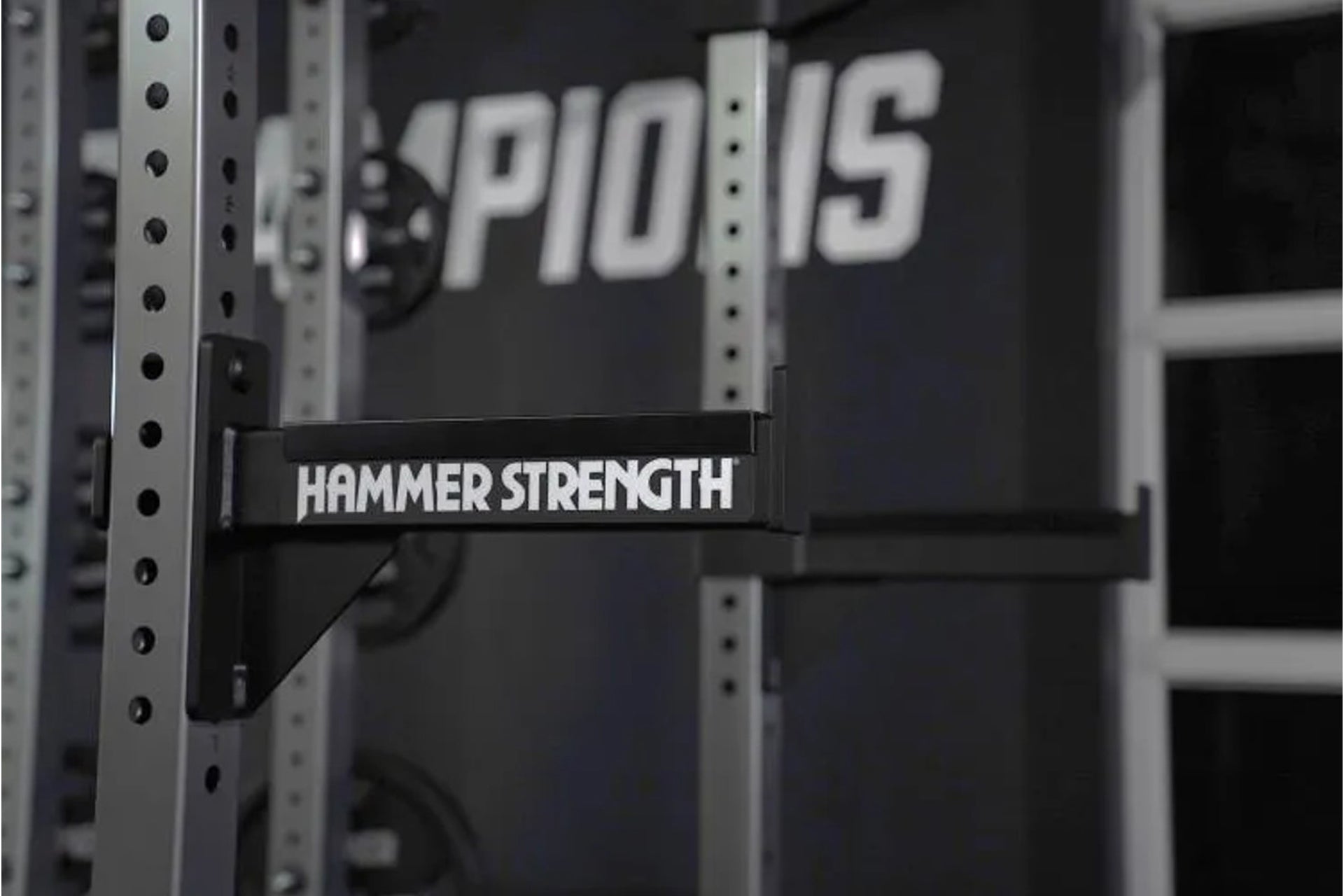 Hammer Strength HD Athletic NX half rack with white text on black horizontal band, silver upright posts with black holes, sho