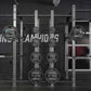 Hammer Strength HD Athletic NX Power Half Combo Rack with white steel frame and black weight plates, front view on dark backg