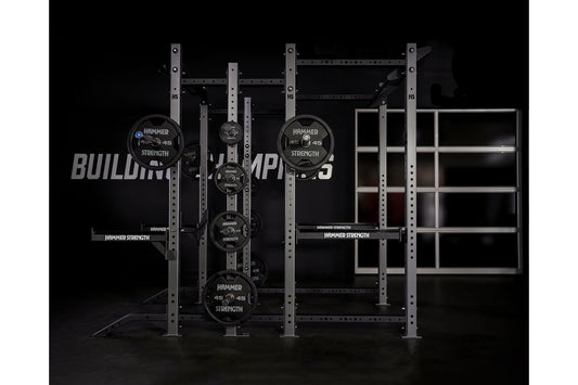 Hammer Strength HD Athletic NX Power Half Combo Rack with black weight plates and steel frame on black background