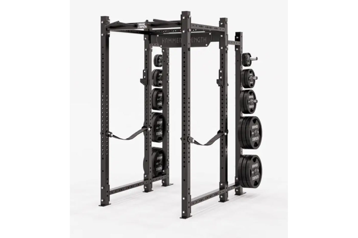 Black Hammer Strength power rack with weight plate storage pegs on right side, holding loaded barrels, on white background
