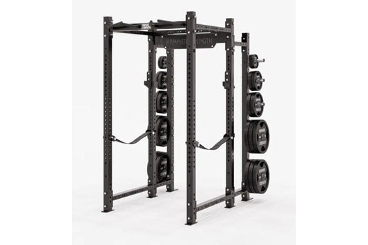 Black Hammer Strength power rack with weight plate storage pegs on right side, holding loaded barrels, on white background