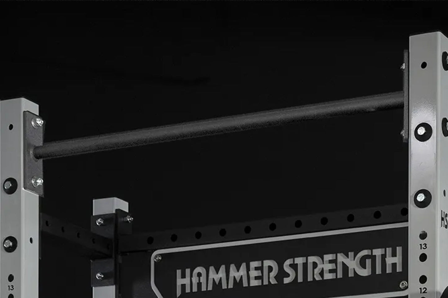 Hammer Strength HD Athletic NX Squat Stand with black steel frame, gray uprights, and safety catches on black background