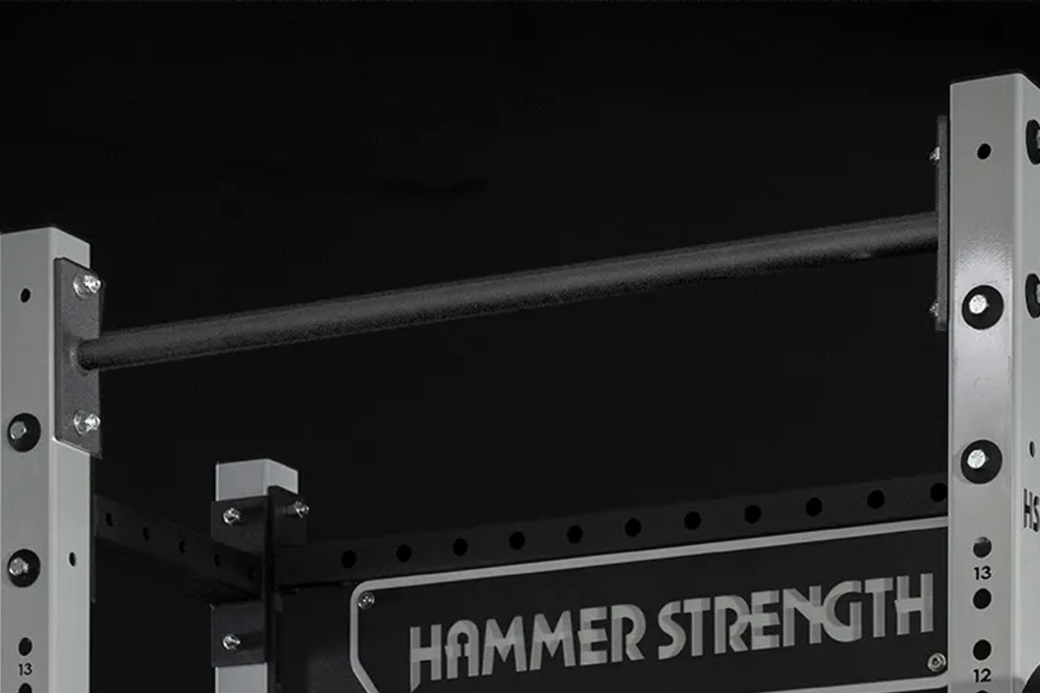 Hammer Strength HD Athletic NX Squat Stand with black steel frame, gray uprights, and safety catches on black background