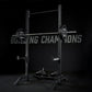 Black Hammer Strength squat stand with loaded barbell, weight plates, and safety bars on dark background