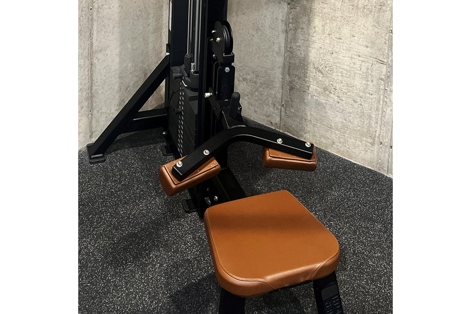 Black and tan leather gym machine with dual pulldown row attachments, pedal footrests, and triangular frame support on rubber