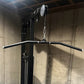 Hammer Strength HD Elite Dual Pulldown Row machine with black curved handles and silver pulley system mounted to concrete wal