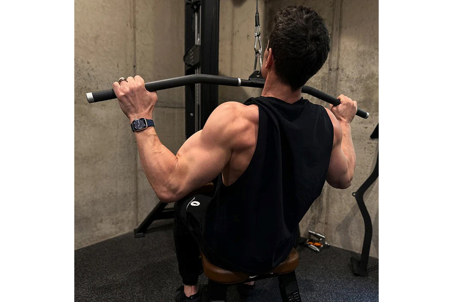 Man performing lat pulldown exercise on Hammer Strength HD Elite Dual Pulldown Row machine in gym setting