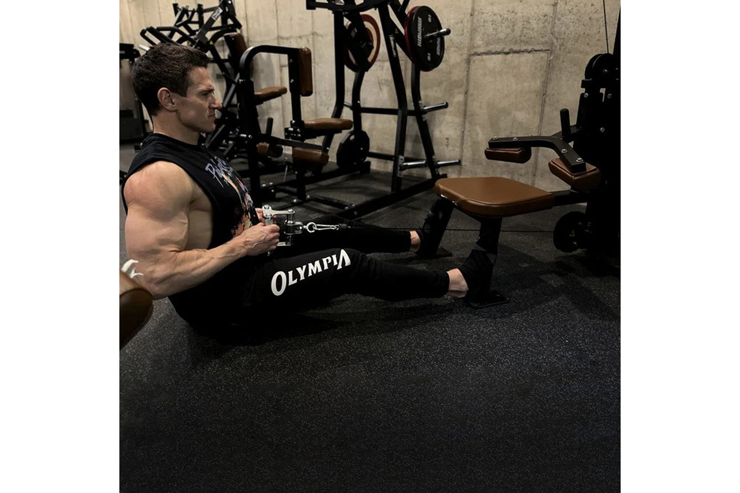 Man using black Hammer Strength HD Elite Dual Pulldown Row machine with cable attachment in gym setting with weight equipment