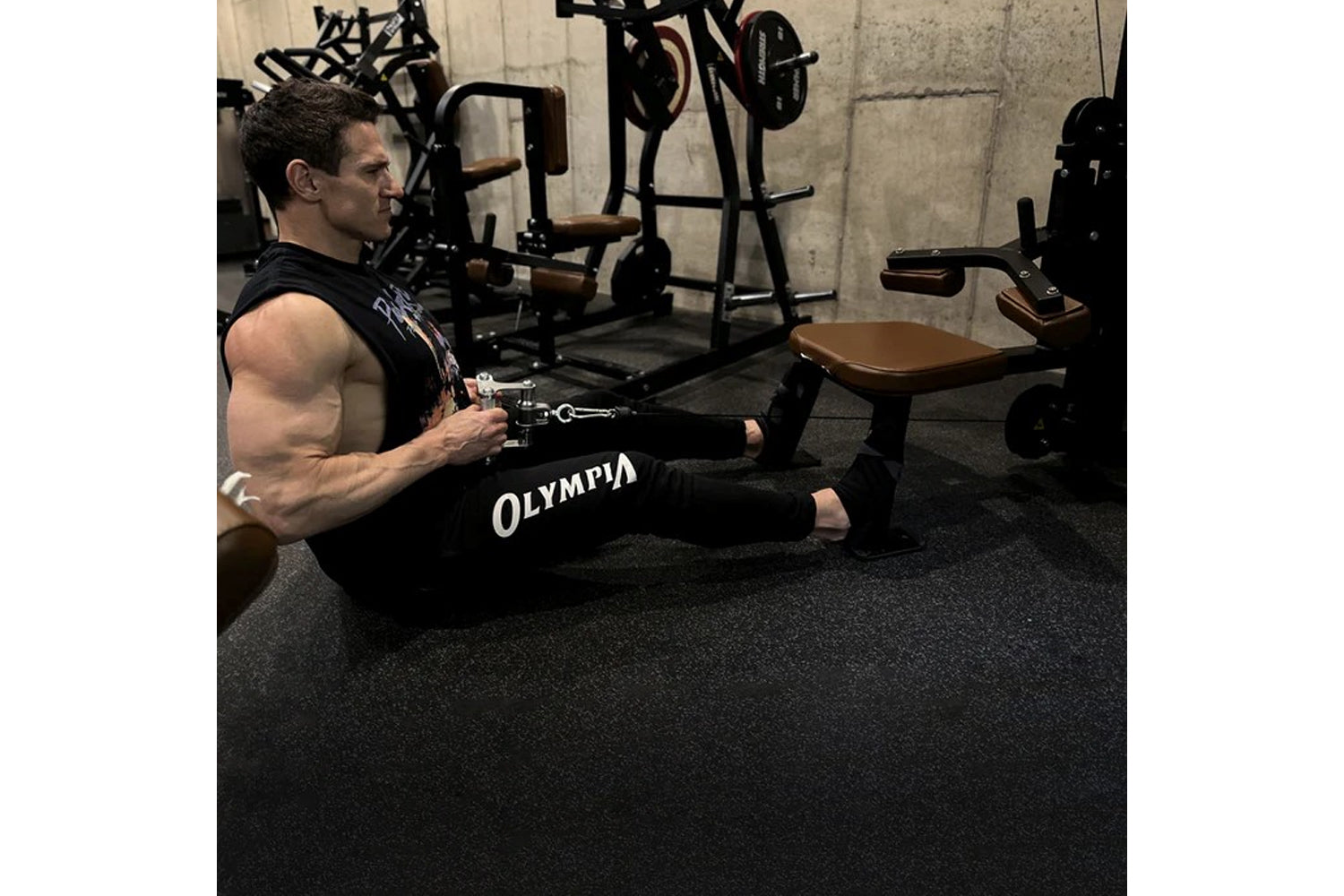 Man using black Hammer Strength HD Elite Dual Pulldown Row machine with cable attachment in gym setting with weight equipment